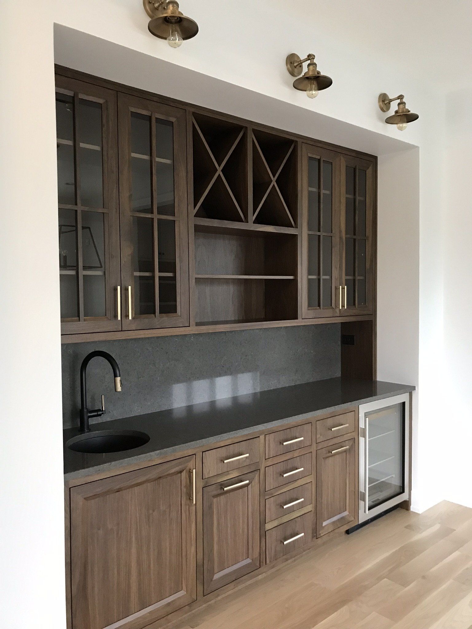 A kitchen with wooden cabinets and a sink