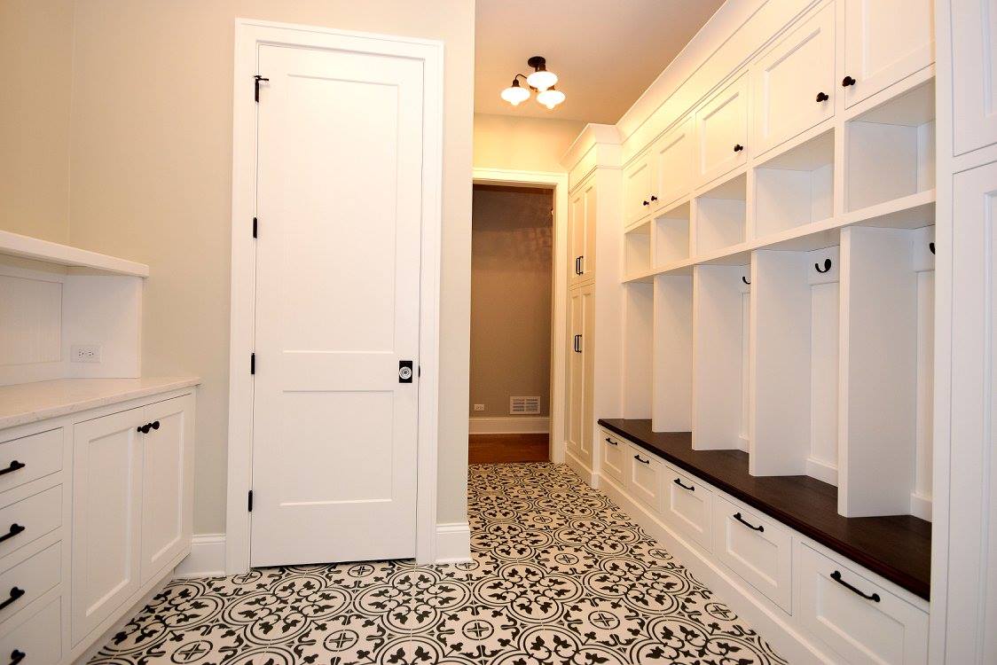 A hallway with lots of shelves and drawers in a house.