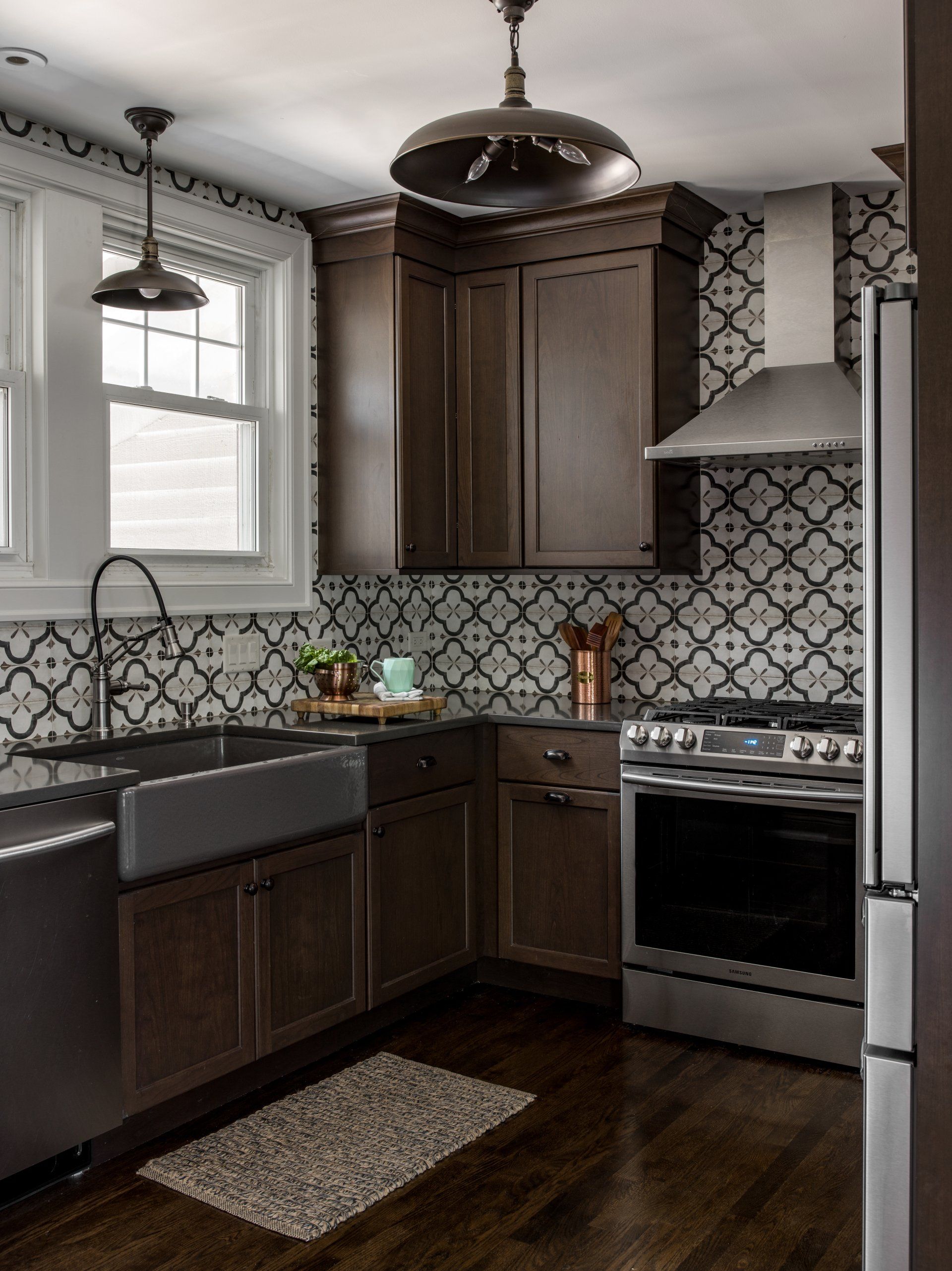 A kitchen with stainless steel appliances and brown cabinets