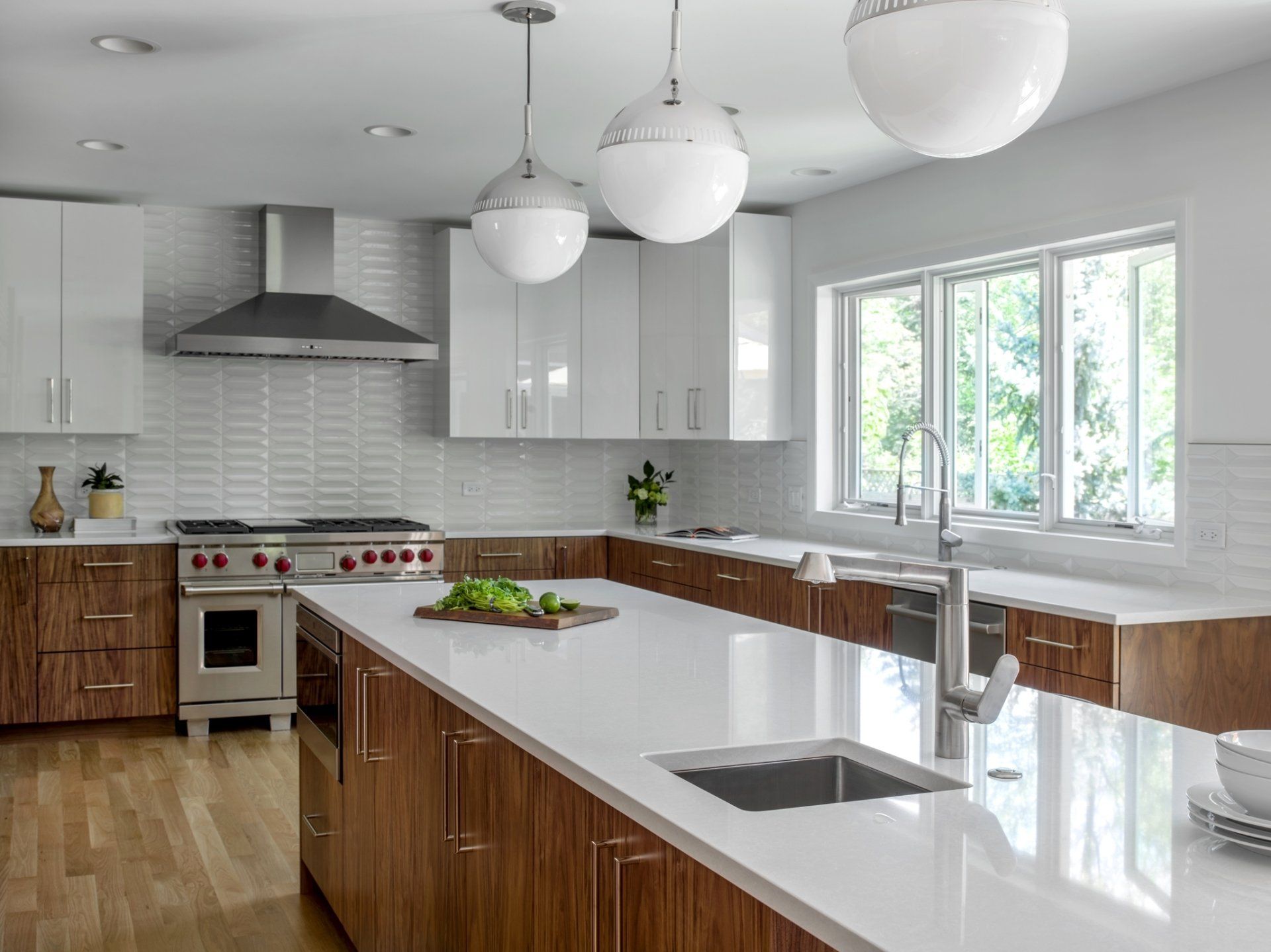 A kitchen with white counter tops , wooden cabinets , a stove and a sink.