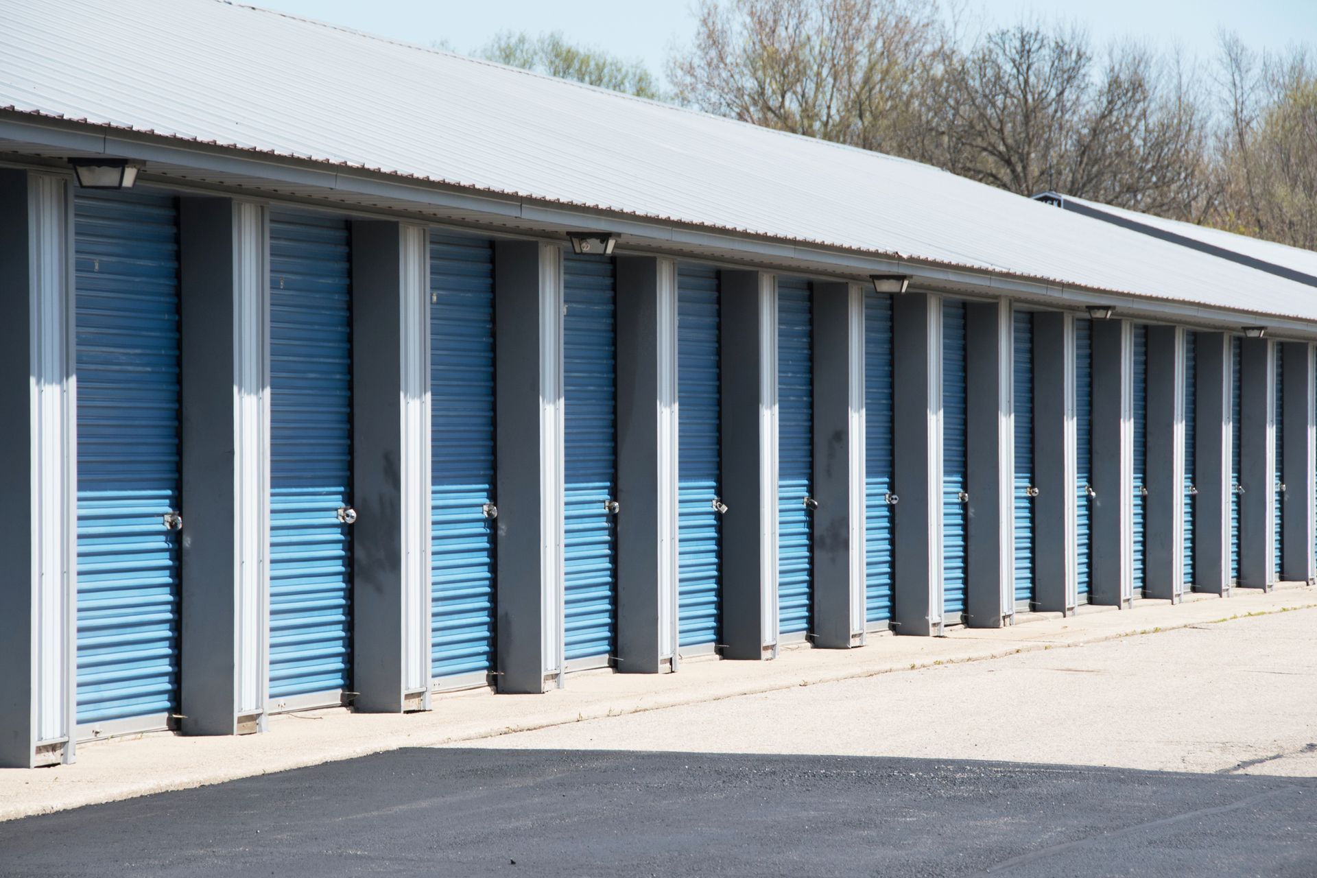 Secure storage units in McLean, VA at Tysons Self Storage featuring blue roll-up doors in a well-mai