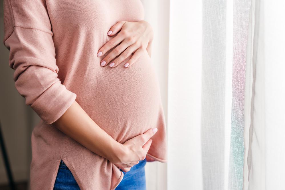 Pregnant Woman Holding Her Tummy — Vienna, VA — Tysons Self Storage