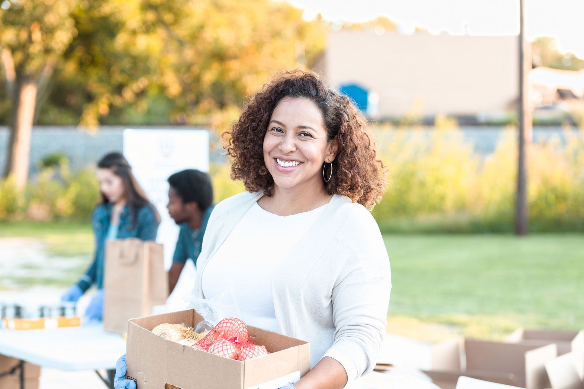 A Woman Is Holding A Box | Elmhurst, IL | R.U. Marketing LLC