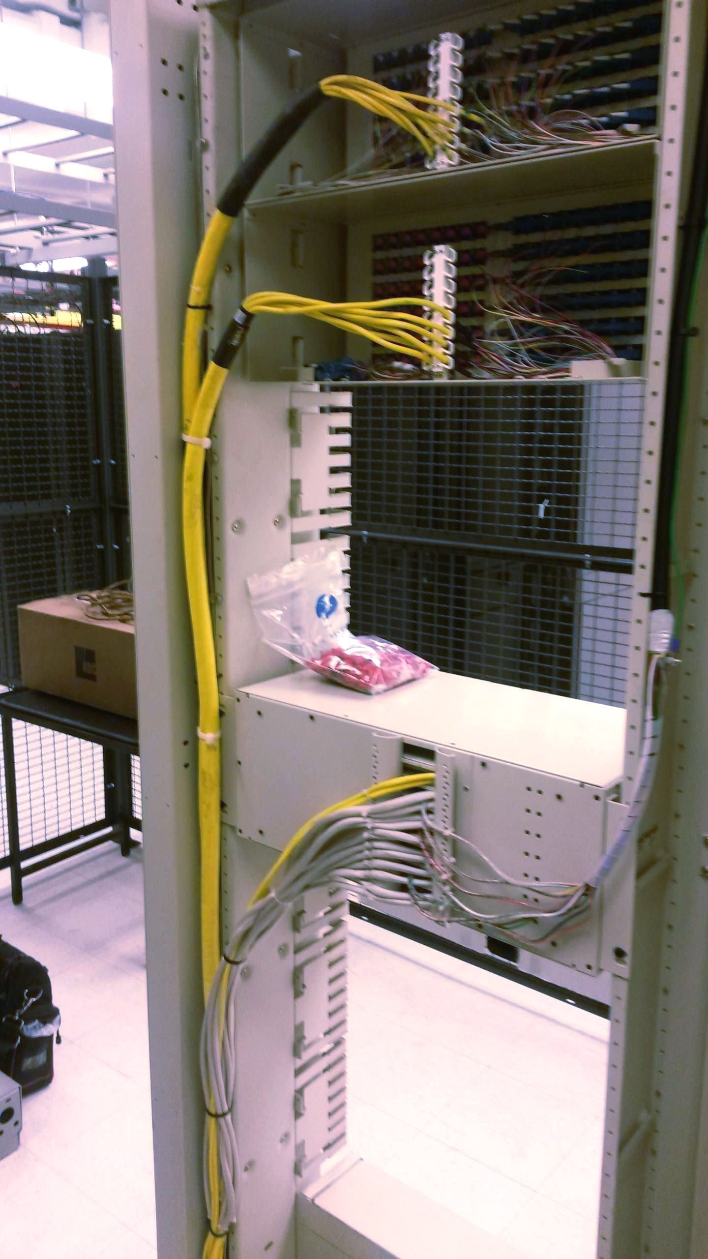 A bunch of wires are connected to a white cabinet