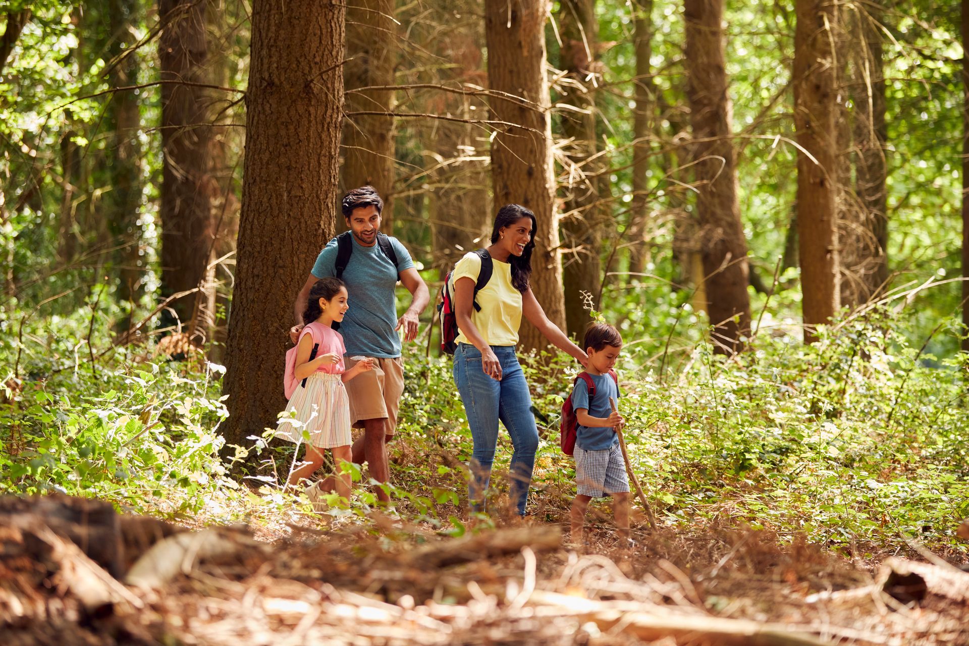 A family is walking through the woods together.