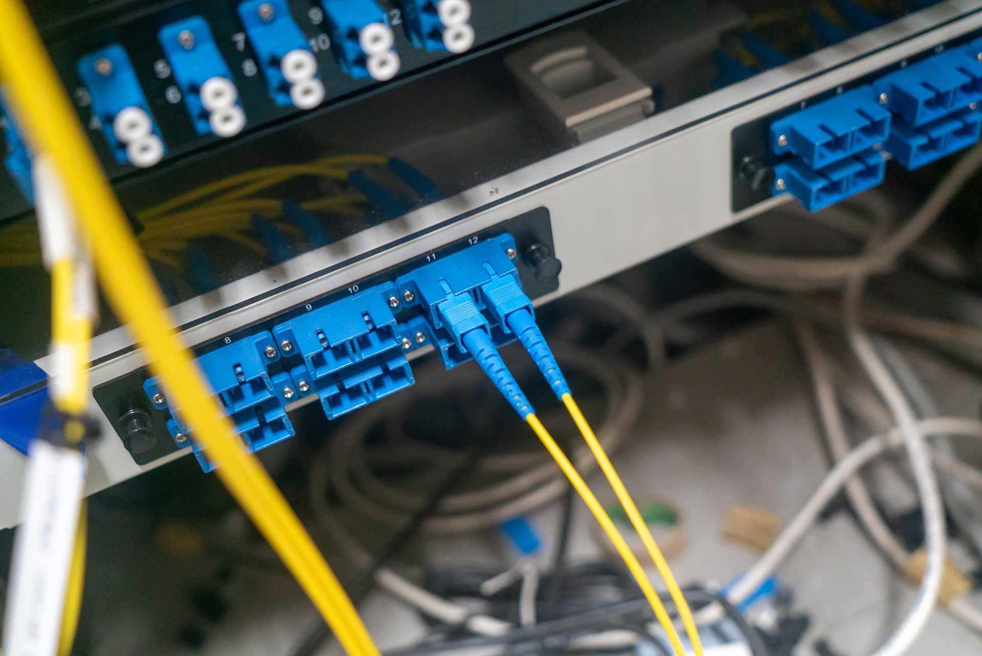 Close-up of fibre optic cables in a data centre installation.