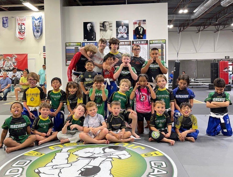 A group of children are posing for a picture in a gym.