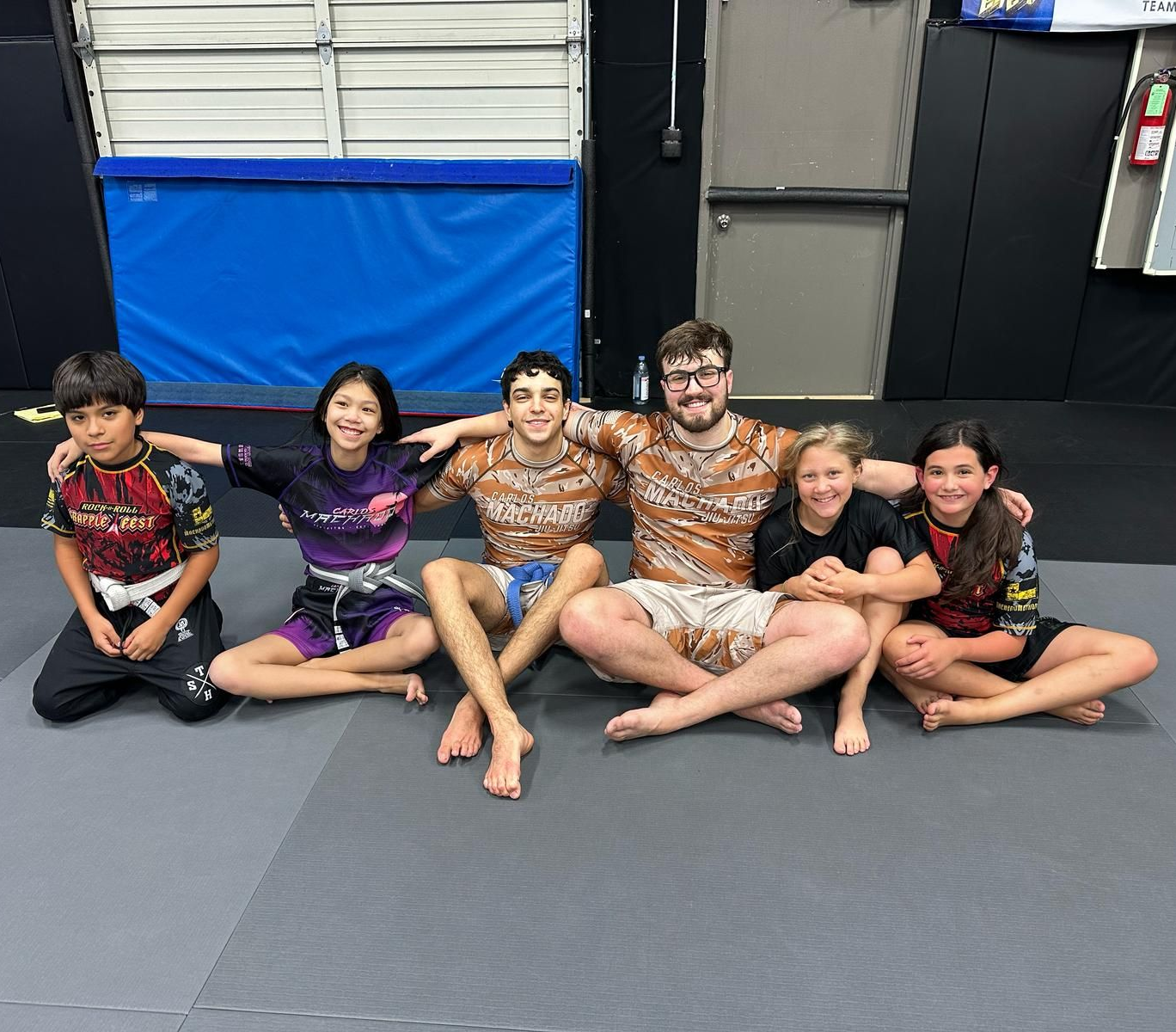A group of men are practicing martial arts in front of an american flag