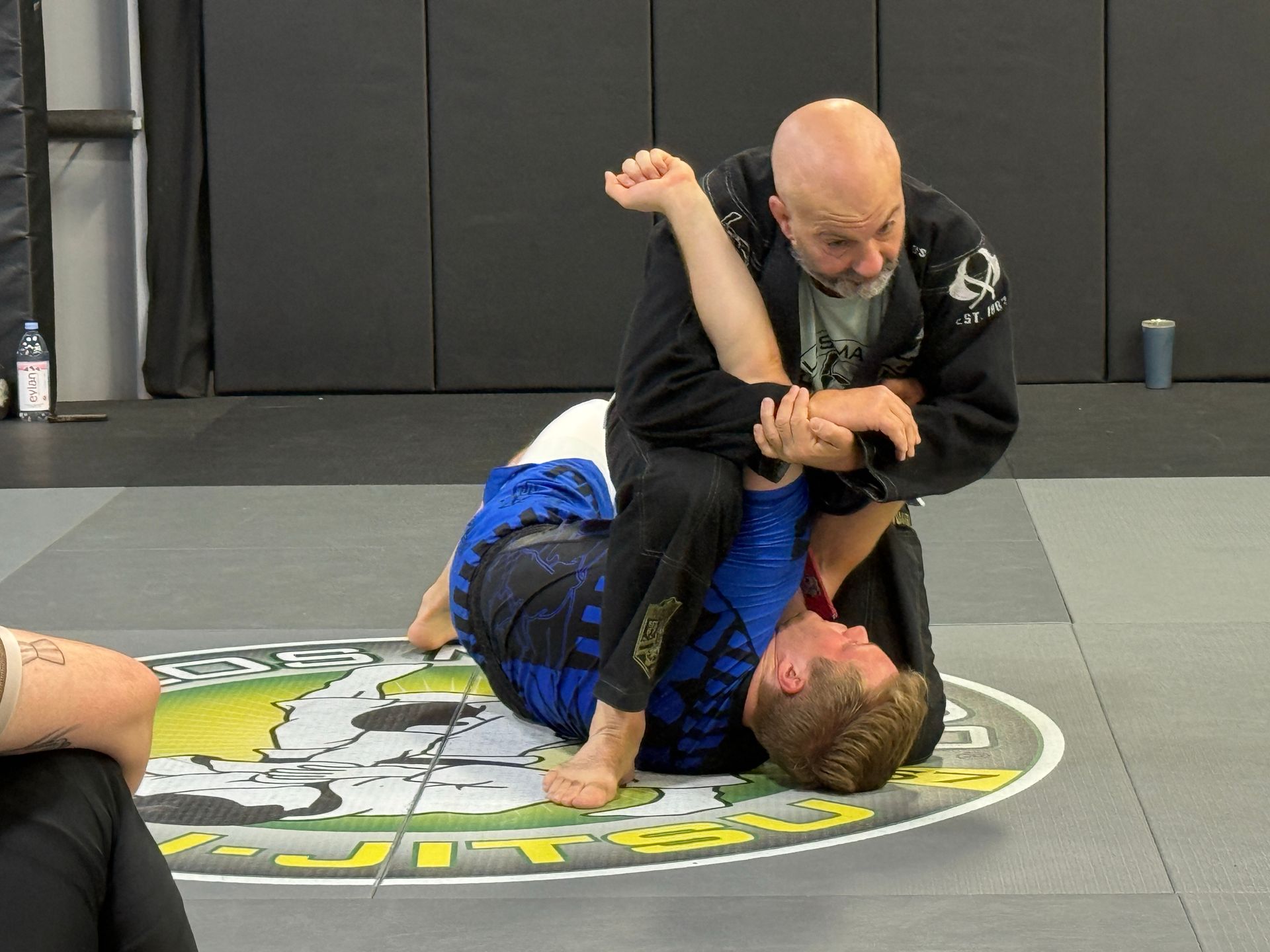 A man and a woman are practicing karate in a gym.