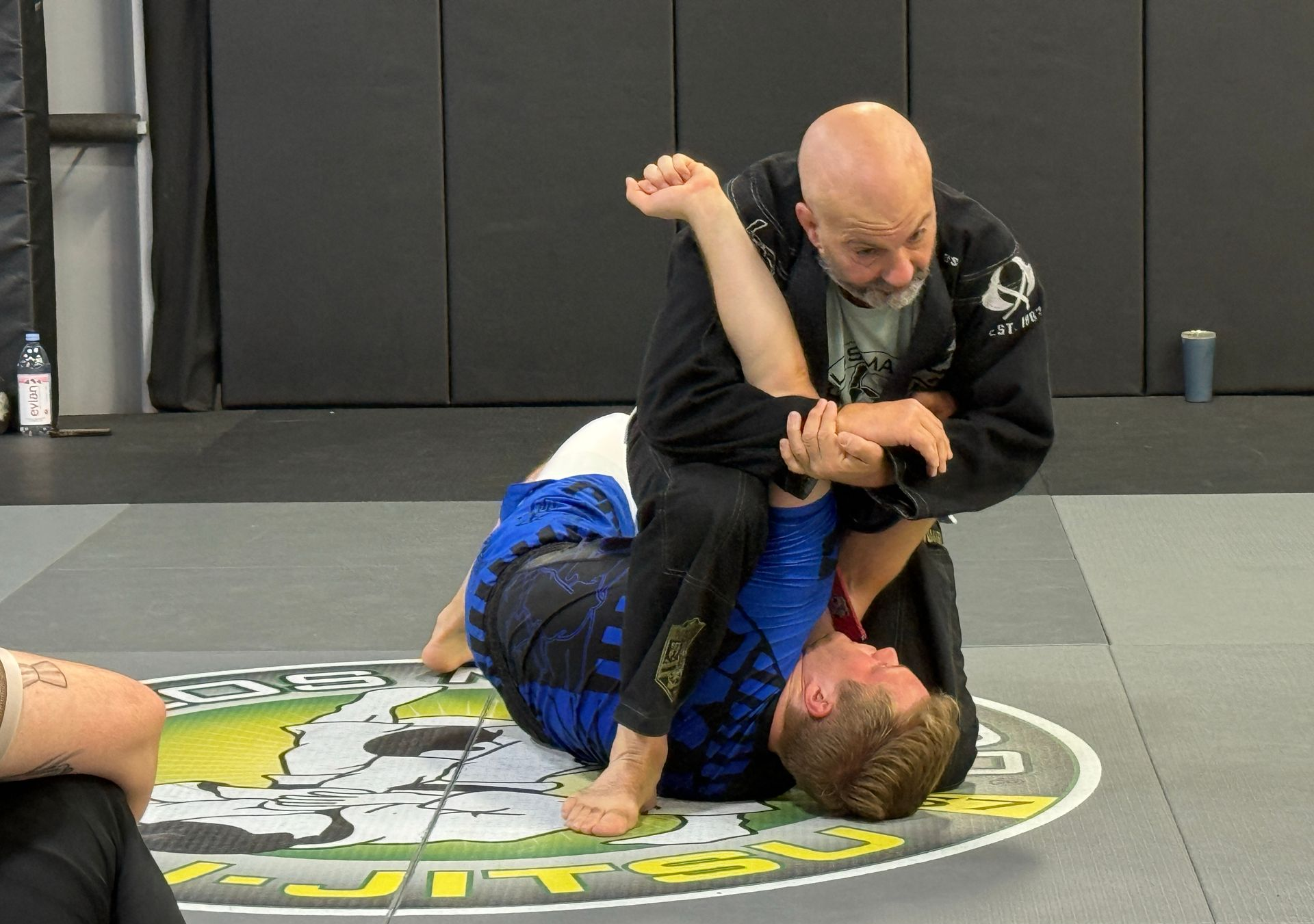 Adult Kickboxer punching towards a man who is training him