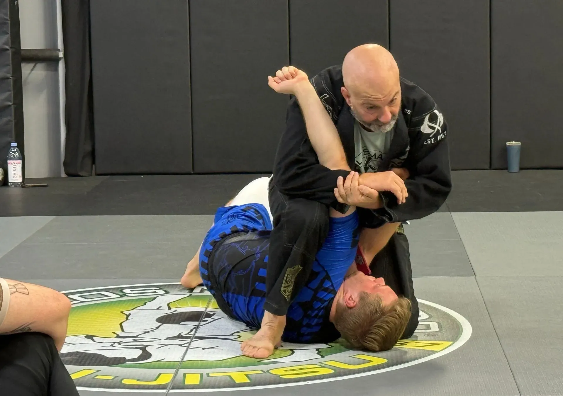A man and a woman are practicing karate in a gym.