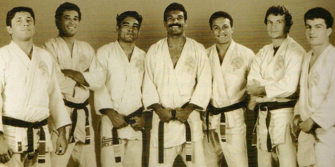 A group of men in karate uniforms are posing for a picture