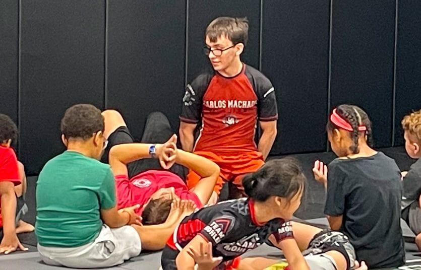 A group of young men are posing for a picture in a gym.
