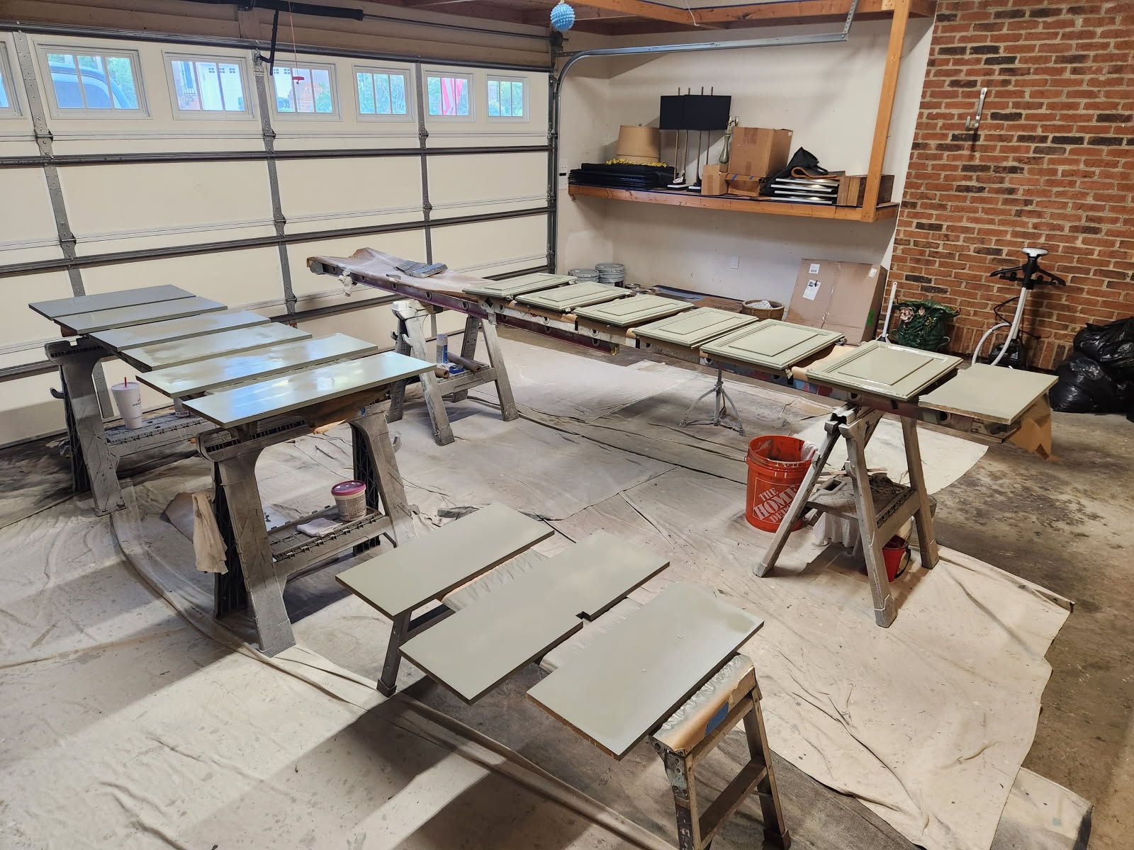 A garage filled with lots of wooden tables and benches.