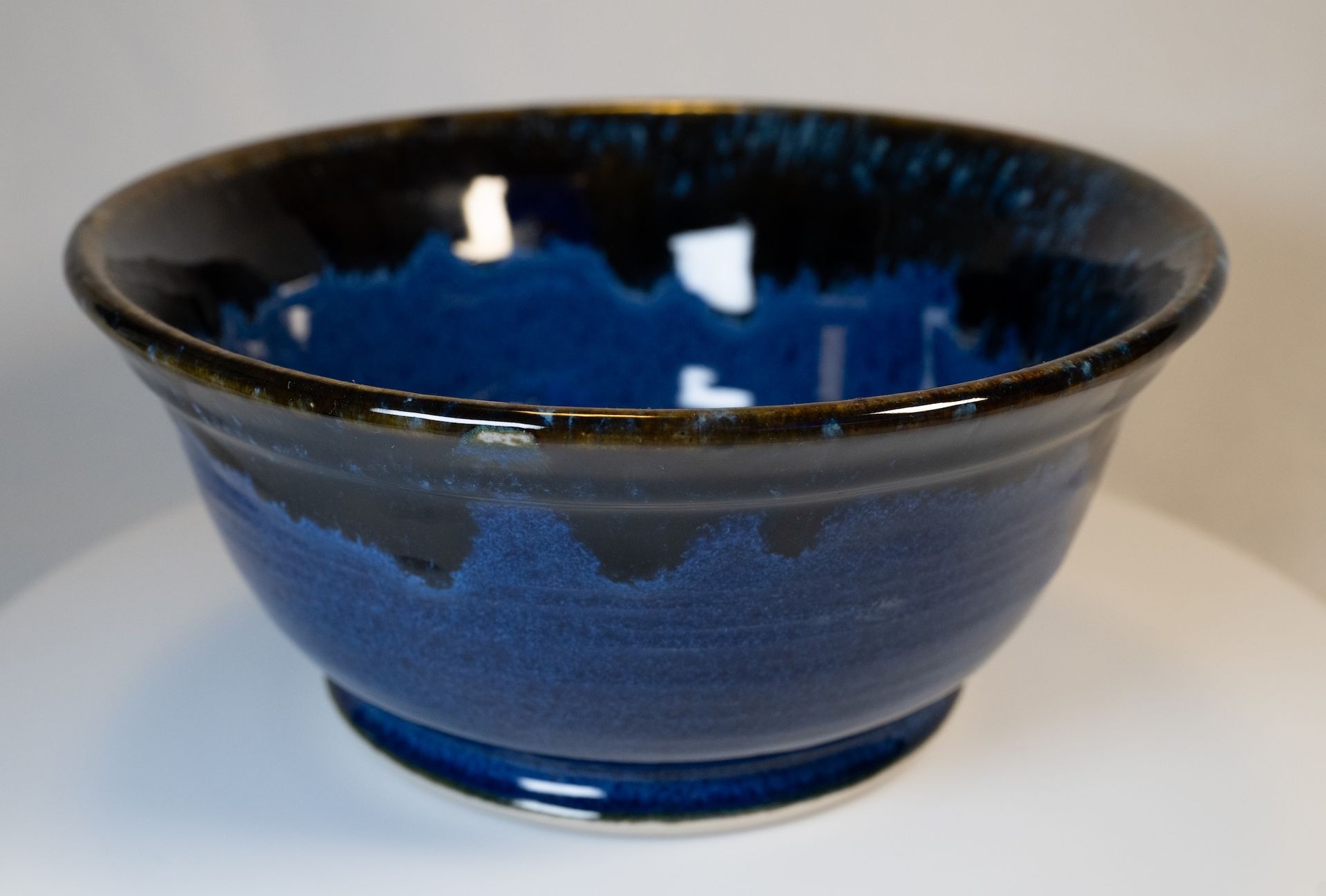 Blue ceramic bowl with dark rim and a glossy interior.
