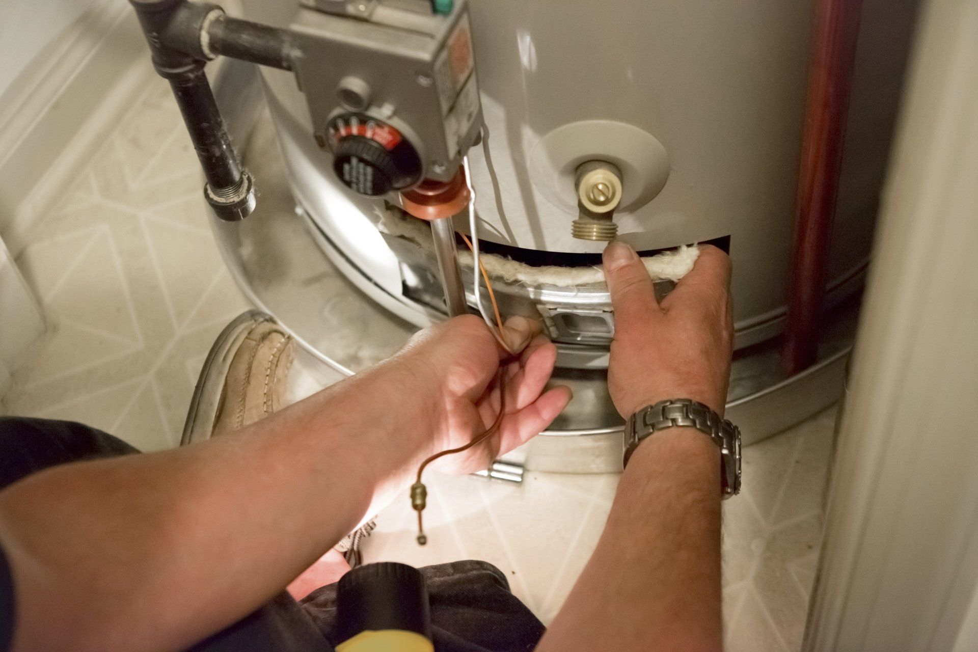 Man fixing water heater - Omaha, NE - Southside Plumbing LLC