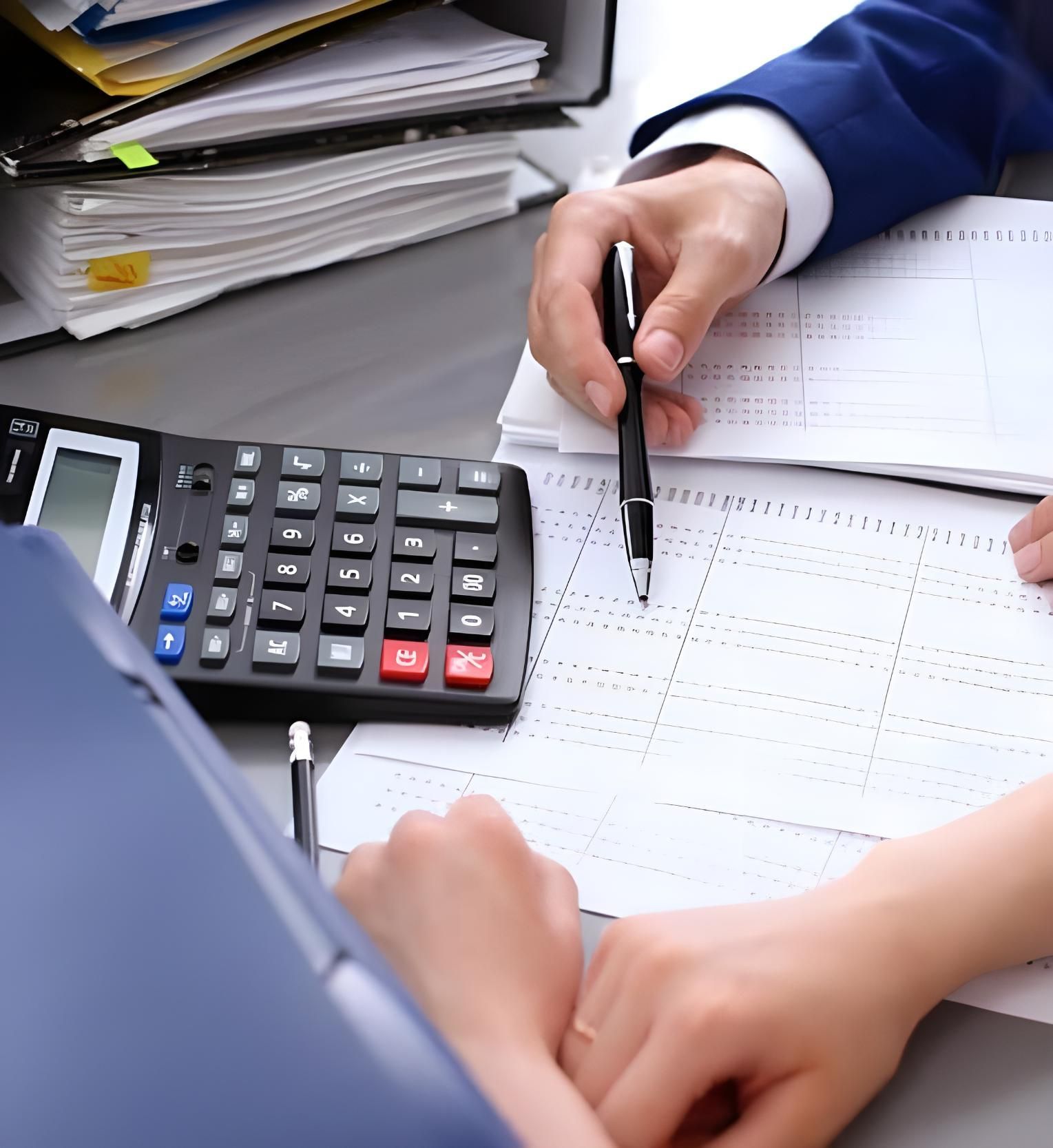 A Person Is Using A Calculator And A Pen — Coast & Country Insurance Consultants Pty Ltd In Central Coast, NSW