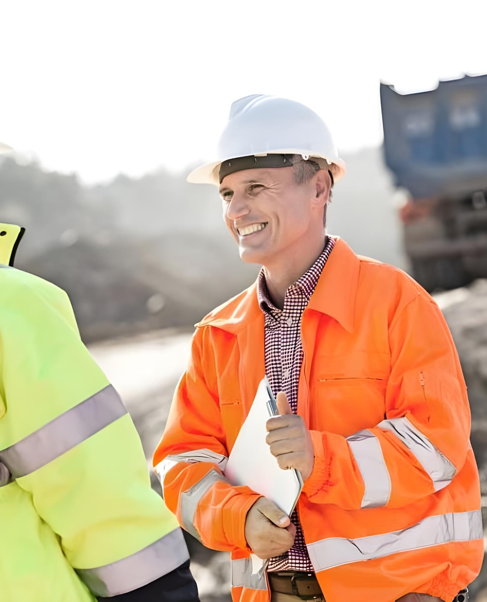 A Man Wearing A Hard Hat And An Orange Jacket Is Giving A Thumbs Up — Coast & Country Insurance Consultants Pty Ltd In Central Coast, NSW