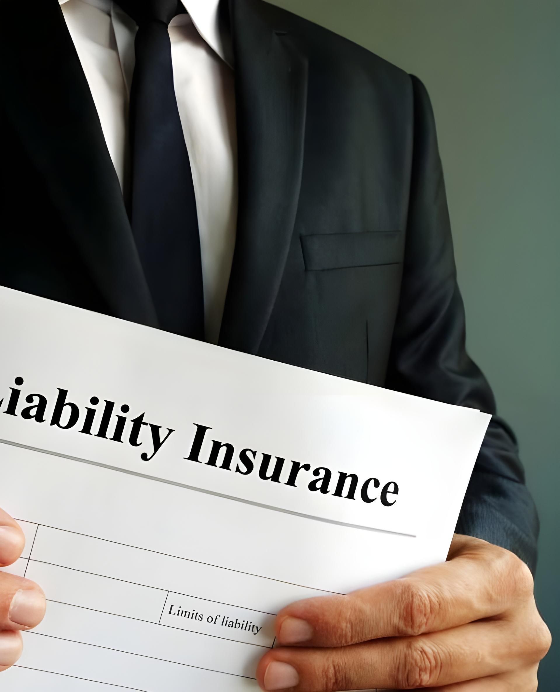 A Man In A Suit And Tie Is Holding A Piece Of Paper That Says Liability Insurance — Coast & Country Insurance Consultants Pty Ltd In Central Coast, NSW