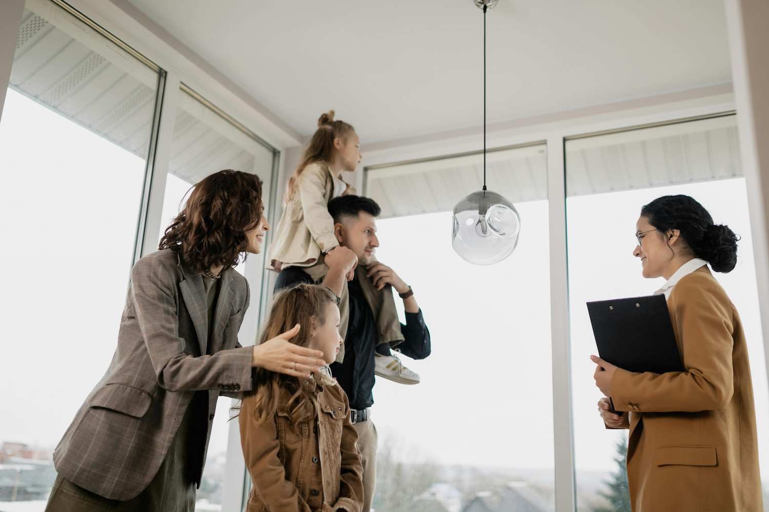 a Family is Looking at a House With a Real Estate Agent — Coast & Country Insurance Consultants Pty Ltd In Central Coast, NSW