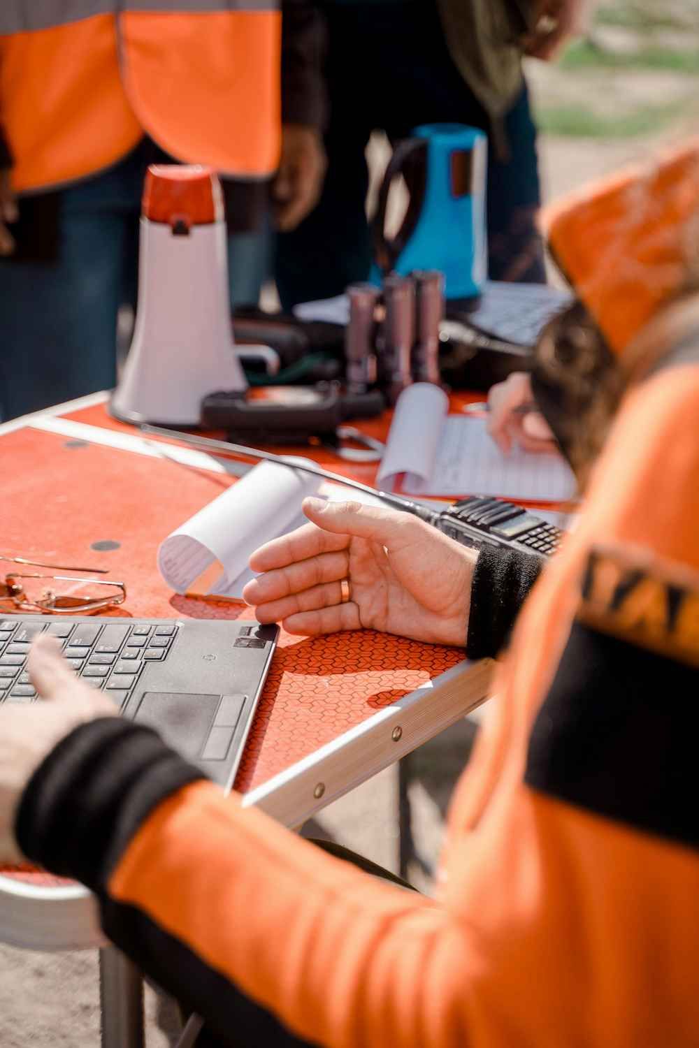 a Person is Sitting at a Table Using a Laptop Computer — Coast & Country Insurance Consultants Pty Ltd In Central Coast, NSW