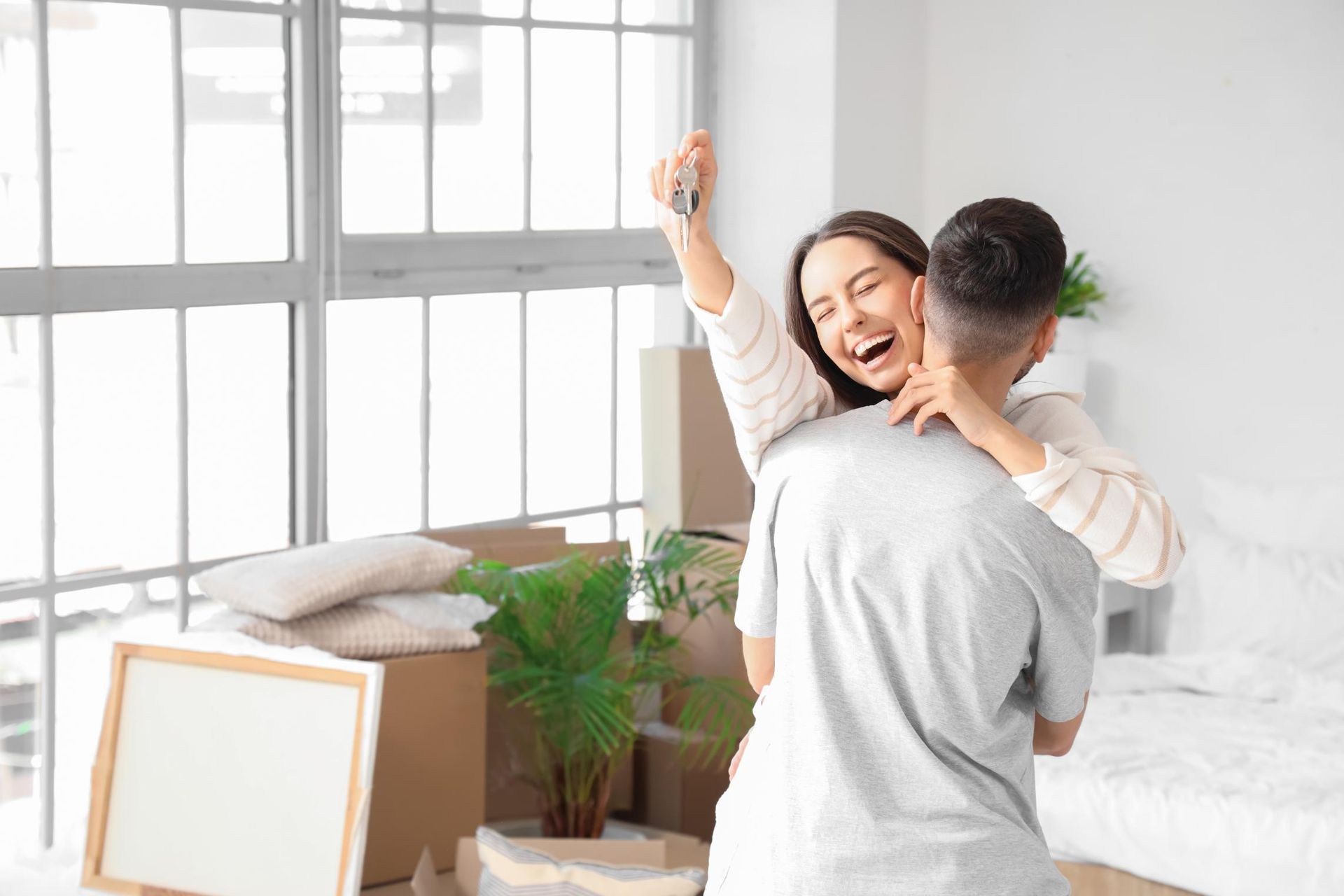 A Person Is Holding A Model House In Their Hands — Coast & Country Insurance Consultants Pty Ltd In Central Coast, NSW