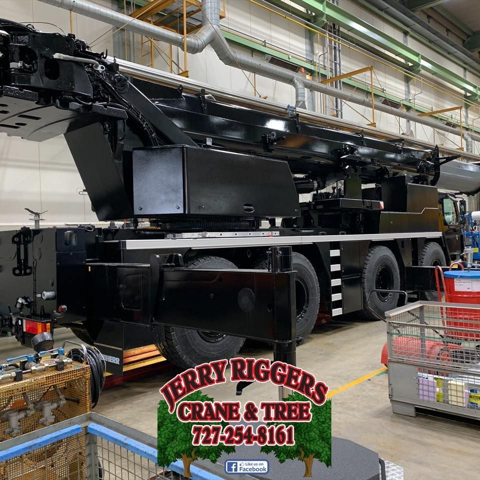 Jerry rigger 's crane and tree is located in a warehouse