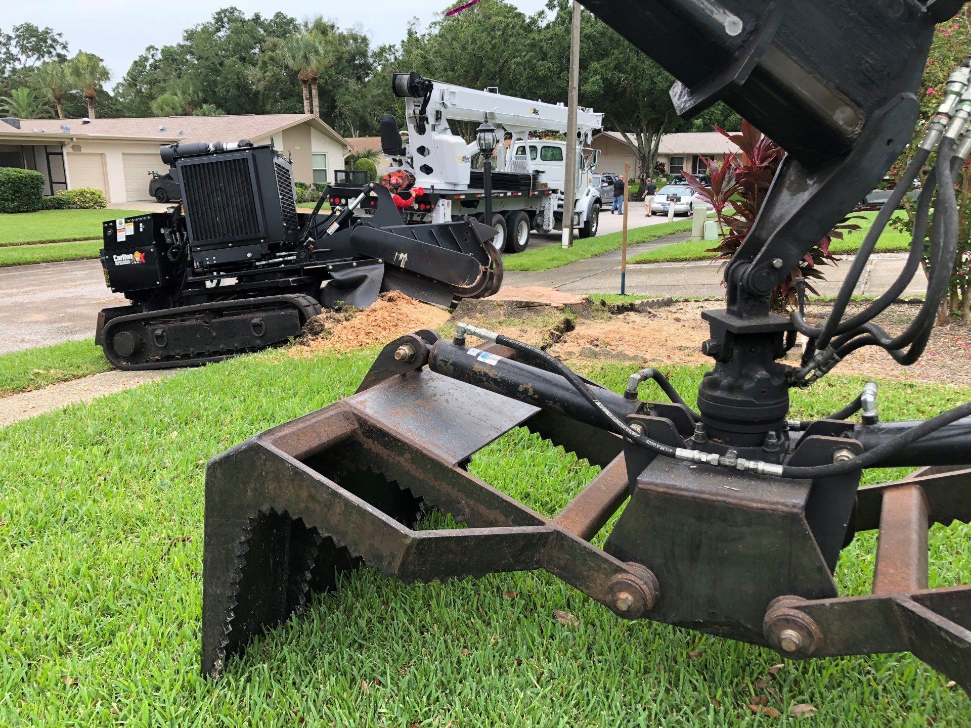A machine is sitting on the grass next to a truck.
