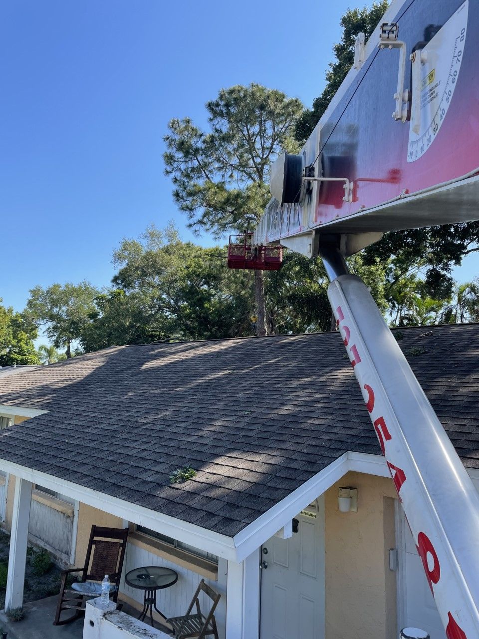 A crane is working on the roof of a house