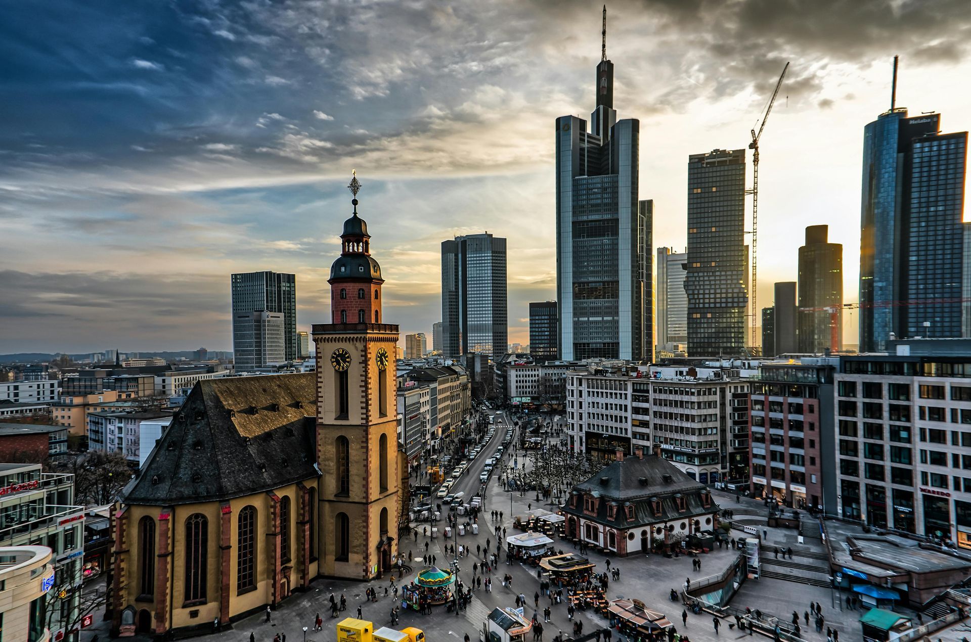 Skyline with church in the foreground and skyscrapers in the background at sunset.