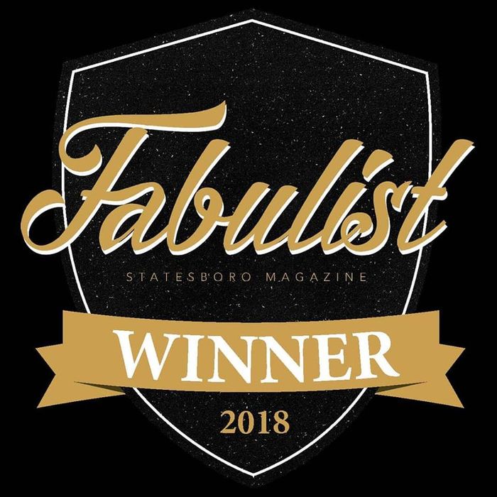 a shield with the words fabulous winner on it