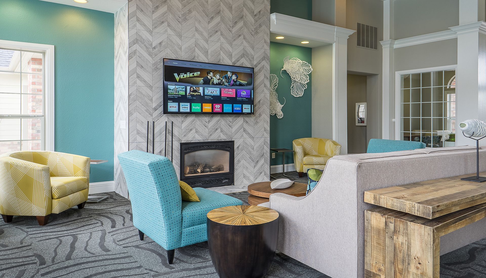 Living room with fireplace, TV, and colorful furniture.