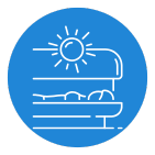 Person lying on a bed under a sun lamp in a blue circle.