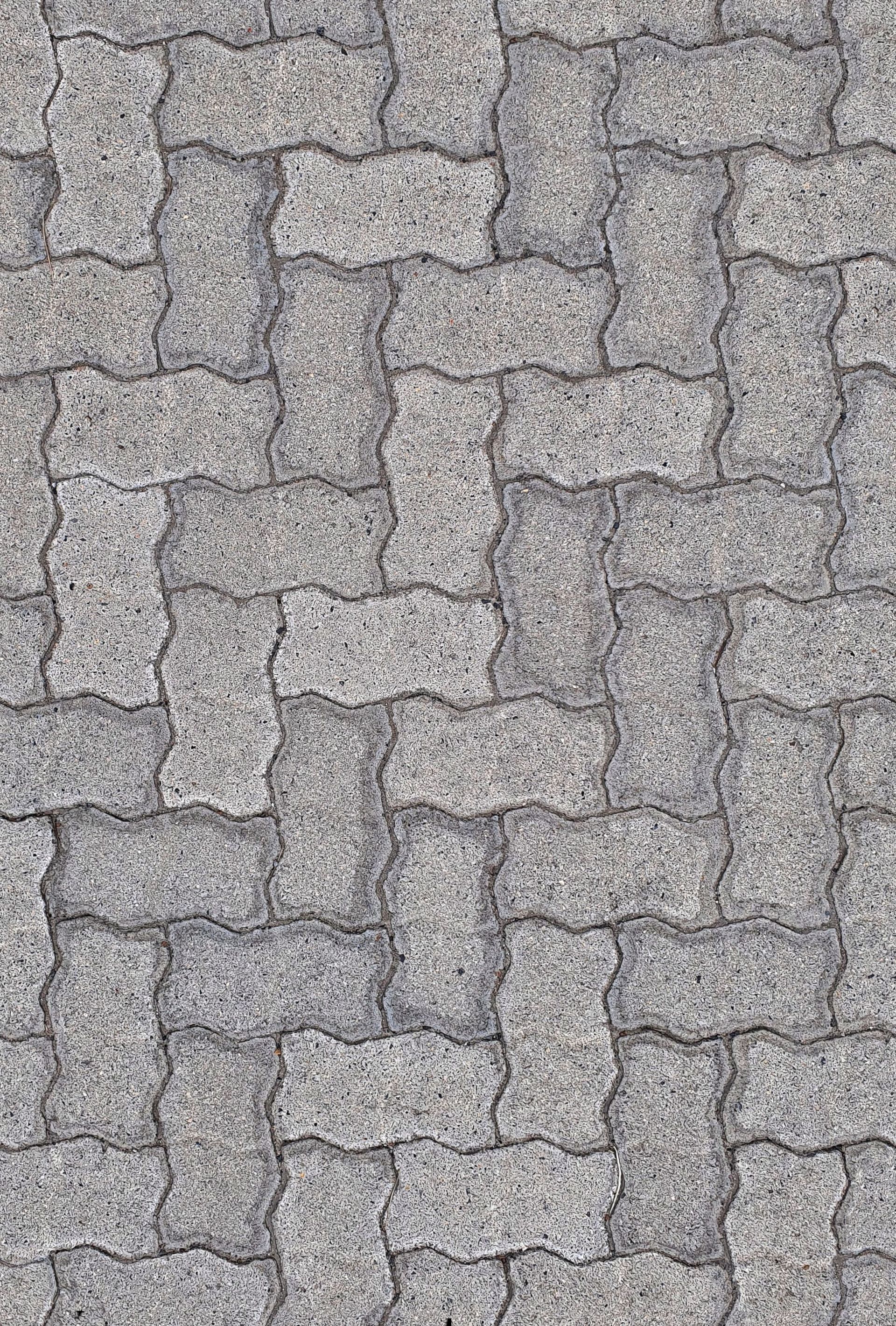 Gray cobblestone pavement with an irregular interlocking stone pattern