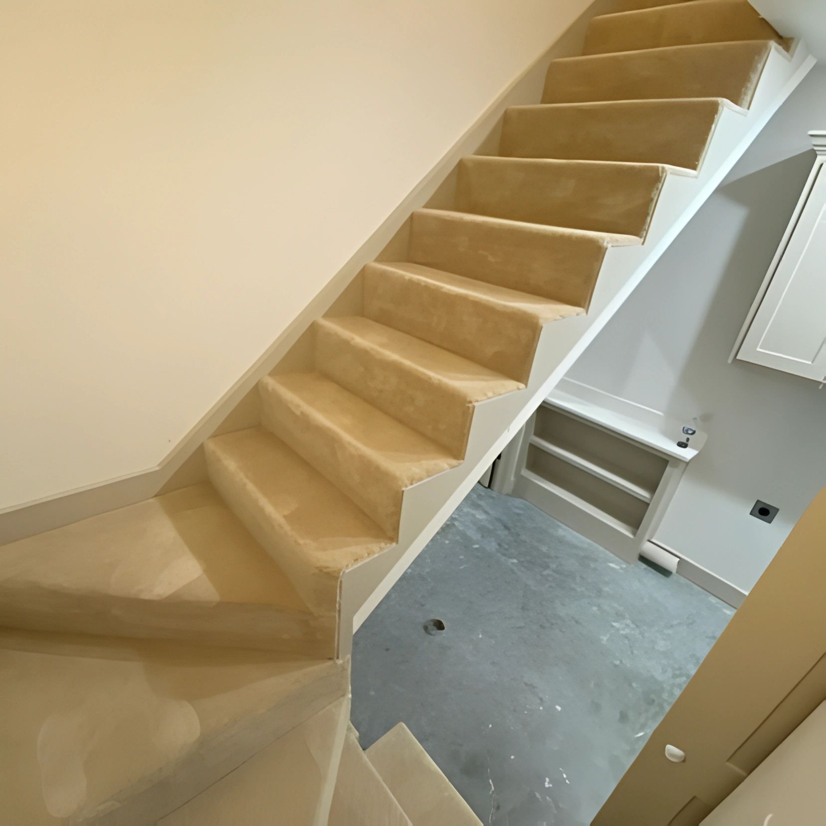 A truck is loaded with rolls of carpet in a parking lot.