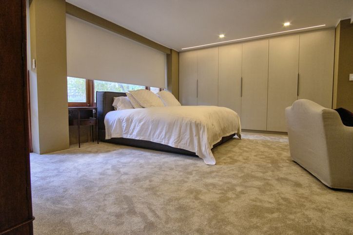 A man and a boy are pushing a trailer full of boxes.