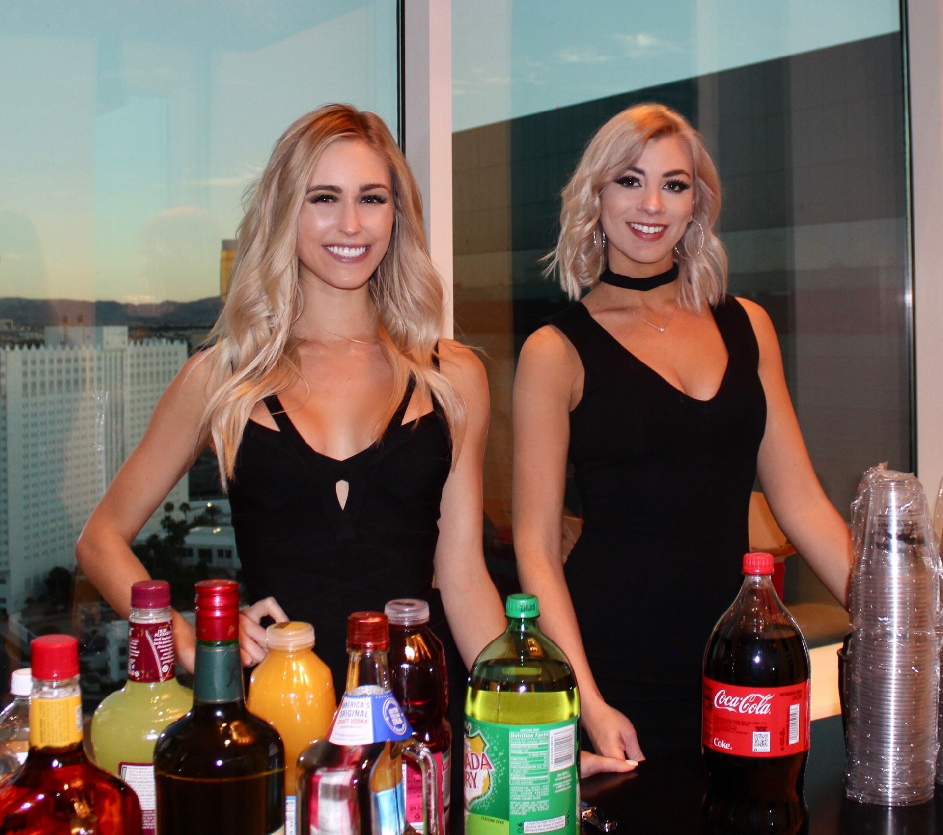 Las Vegas model bartenders in little black dress pour drinks for private event at the MGM Grand.