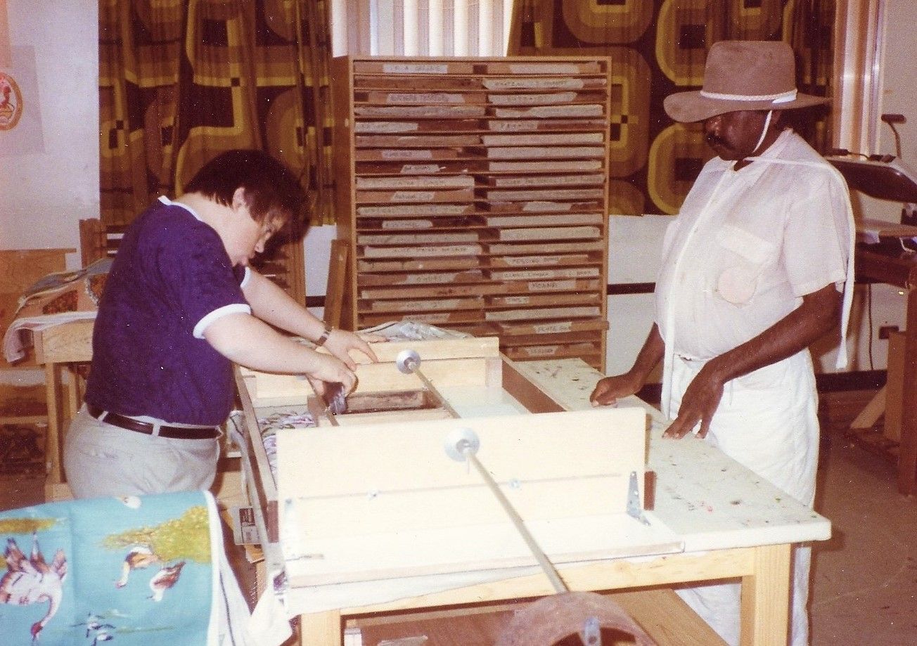 A man and a woman are working on a machine