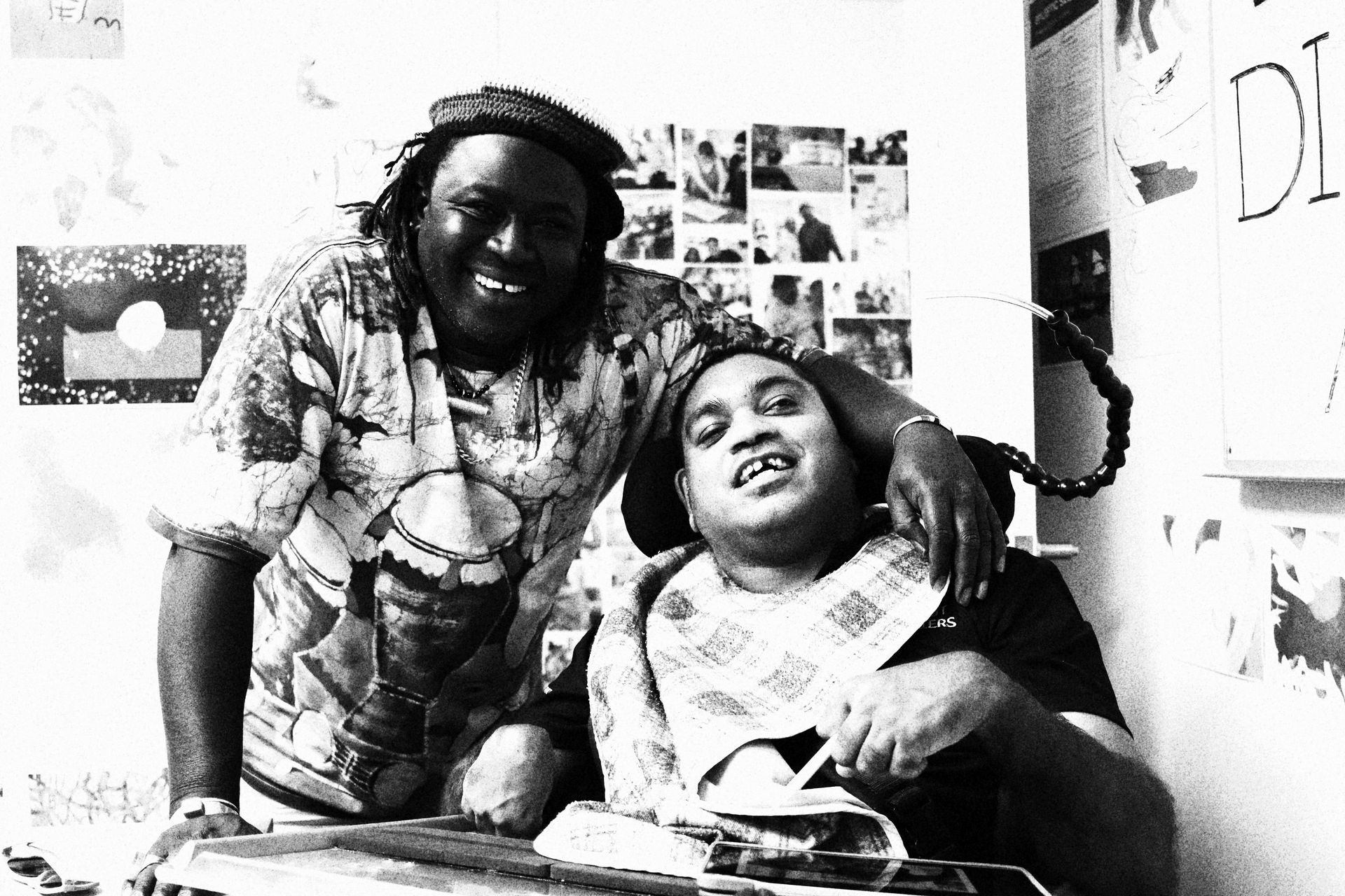 Two men are posing for a picture together in a black and white photo.