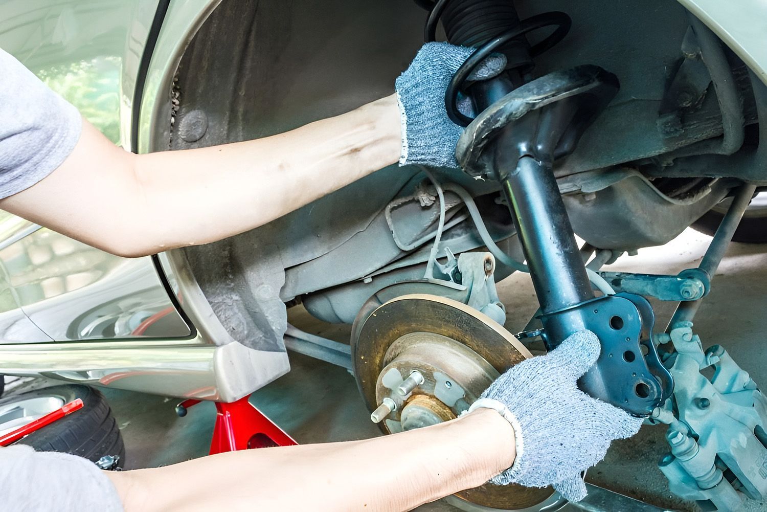 Mechanic Checking A Car Suspension