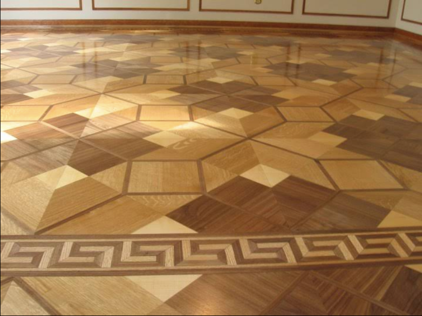 Decorative parquet wood floor with geometric patterns and a Greek key border in a room