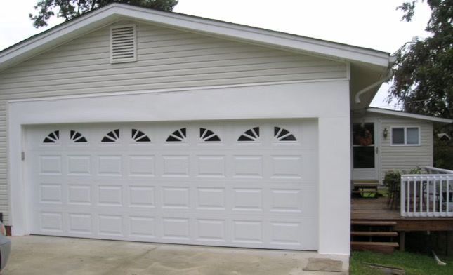 A white house with a large white garage door