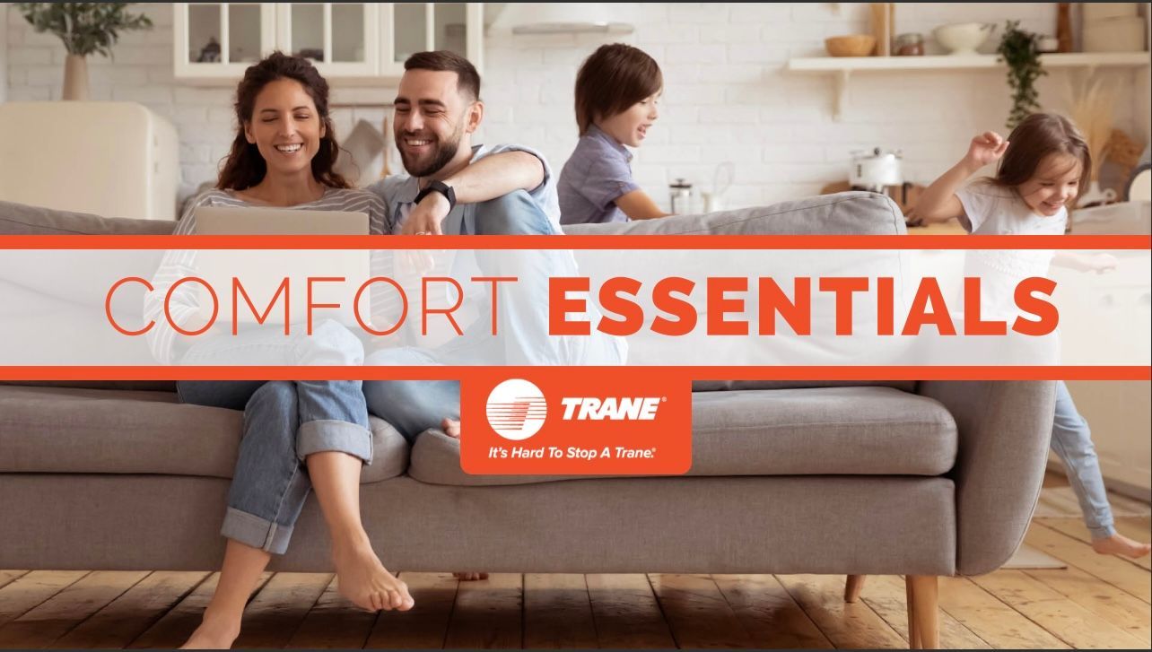 A family is sitting on a couch in a living room.