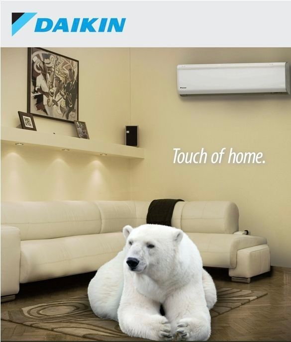 An advertisement for daikin air conditioners with a polar bear laying on the floor