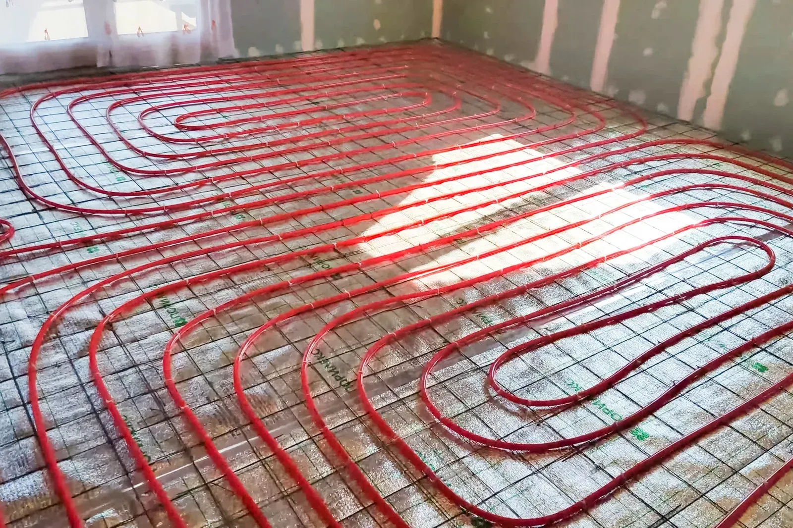 A room with a lot of red pipes on the floor.