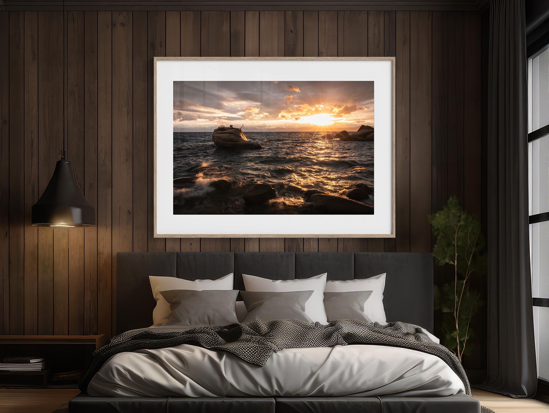 Modern bedroom with a large sunset seascape above the bed