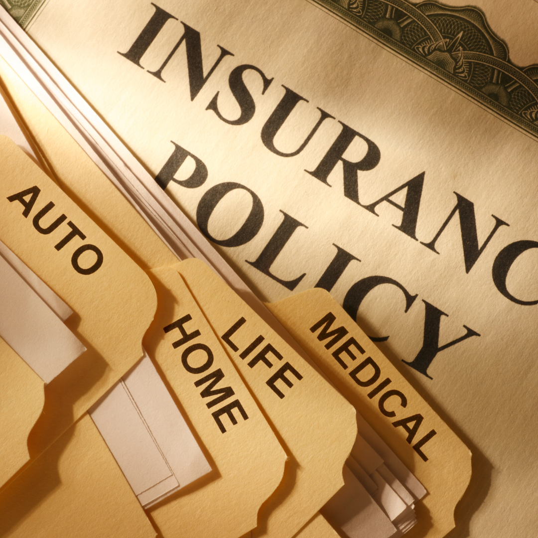 An insurance claim form with glasses a pen and a calculator