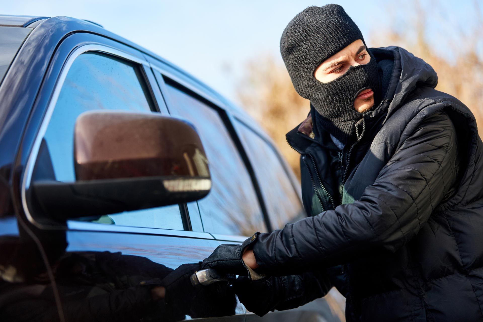 Car thief checking surroundings in a Toronto neighbourhood