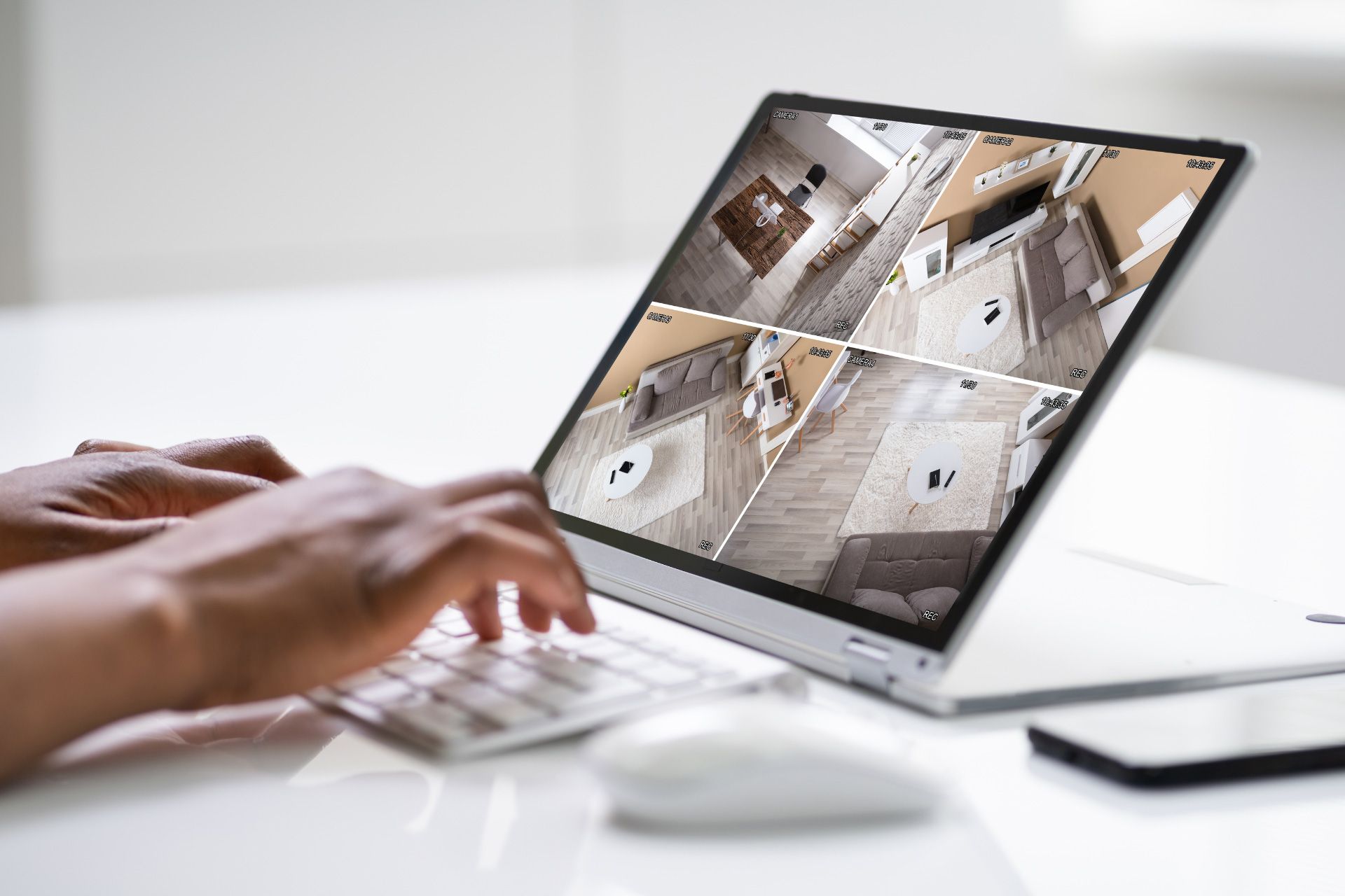 Person using a laptop to view security footage