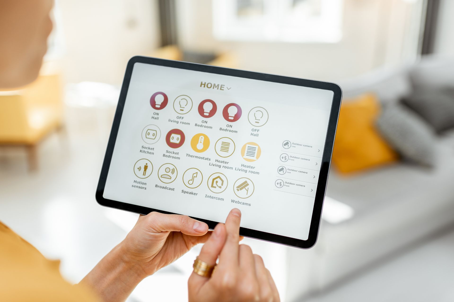 A homeowner holding a tablet, controlling smart home devices and appliances